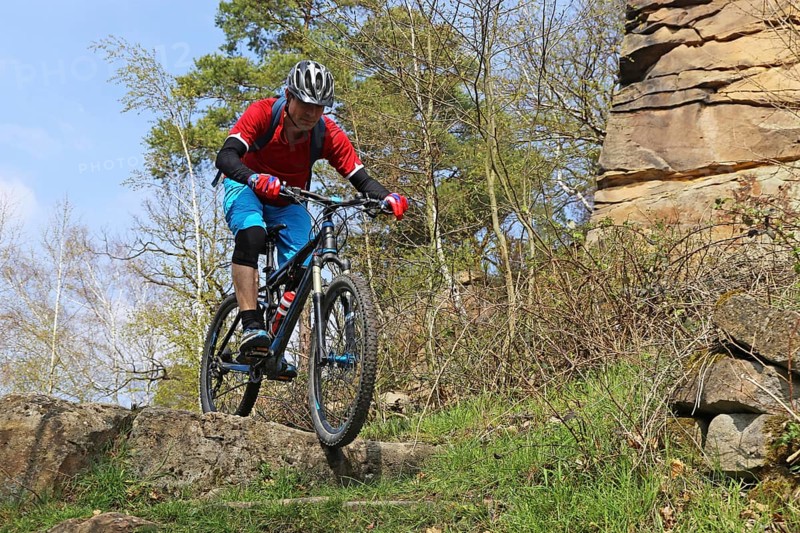 Mountain biker in difficult terrain in the Palatinate Forest near Wolfsburg