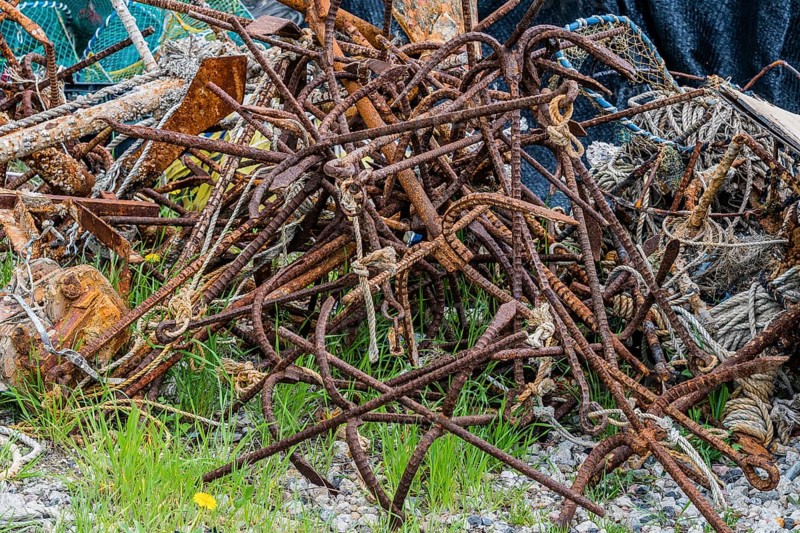 Closeup of large rusty iron grappling hooks used in fishing industry in South Korea
