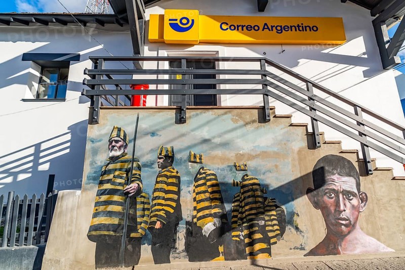 Graffito with men in convict clothing as a reminder of the historic penal colony on the post office building, Ushuaia, Tierra del Fuego Island, Patagonia, Argentina, South America