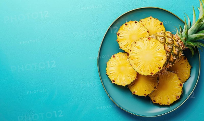 Pineapple slices on blue plate over blue background. Top view with copy space AI generated
