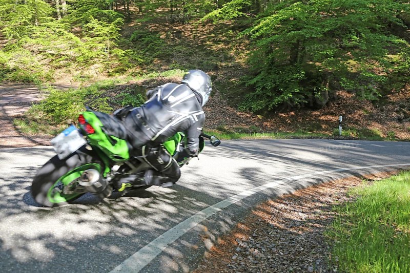 Sporty motorcyclist on a trip into the countryside (Edenkoben Valley, Palatinate Forest)