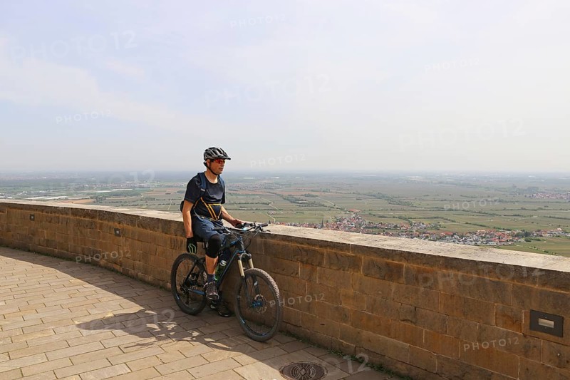 Mountain biker enjoys the view of the Rhine plain from Hambach Castle