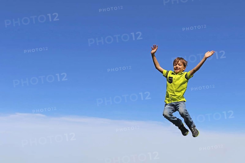 Symbolic image: Boy jumping into the air, blue sky in the background