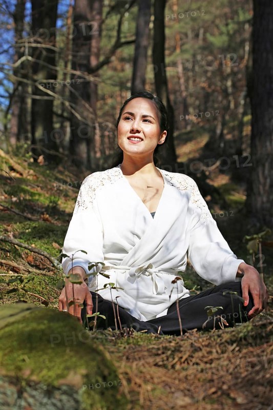 Young woman bathing in the forest (Shinrin Yoku), nature therapy from Japan