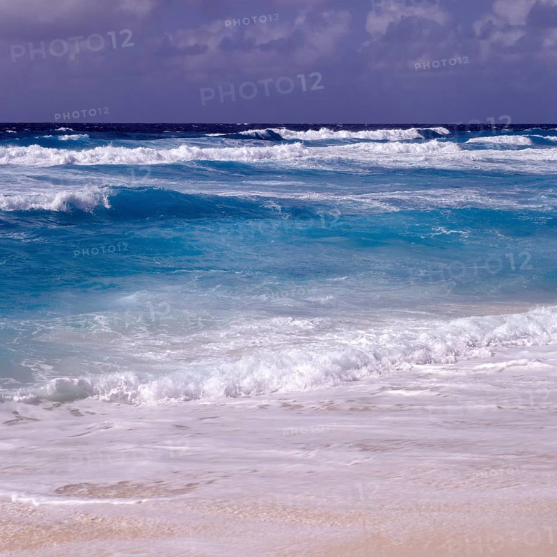 Waves in a storm on La Digue at Grand Anse beach, Seychelles, Africa
