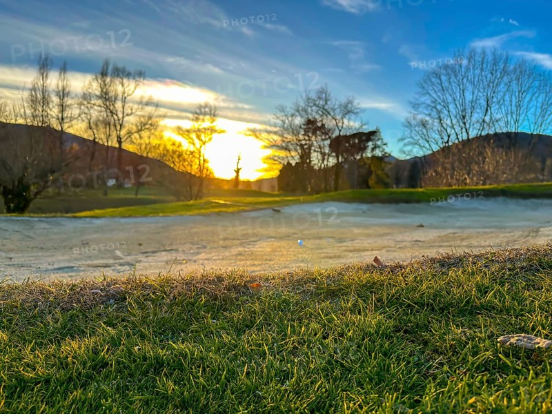 Golf Ball in a Sand Trap on Golf Course in Sunset in a Sunny Day in Switzerland