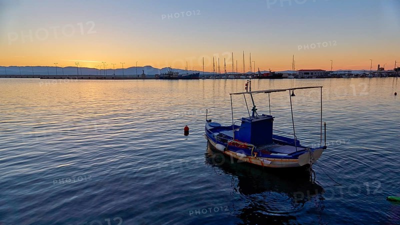 Lonely boat on the sea during a calm sunset, Gythio, Mani, Peloponnese, Greece, Europe