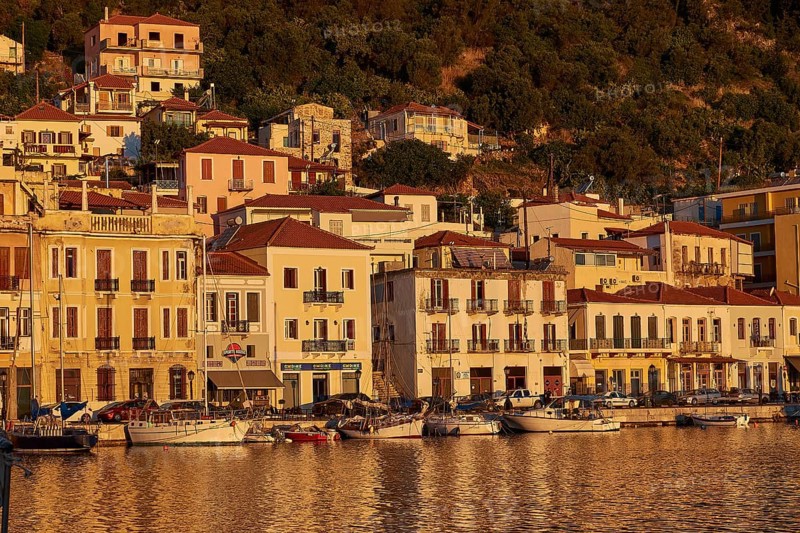 The harbour with sailing boats shines in the golden light of the sunset, Gythio, Mani, Peloponnese, Greece, Europe