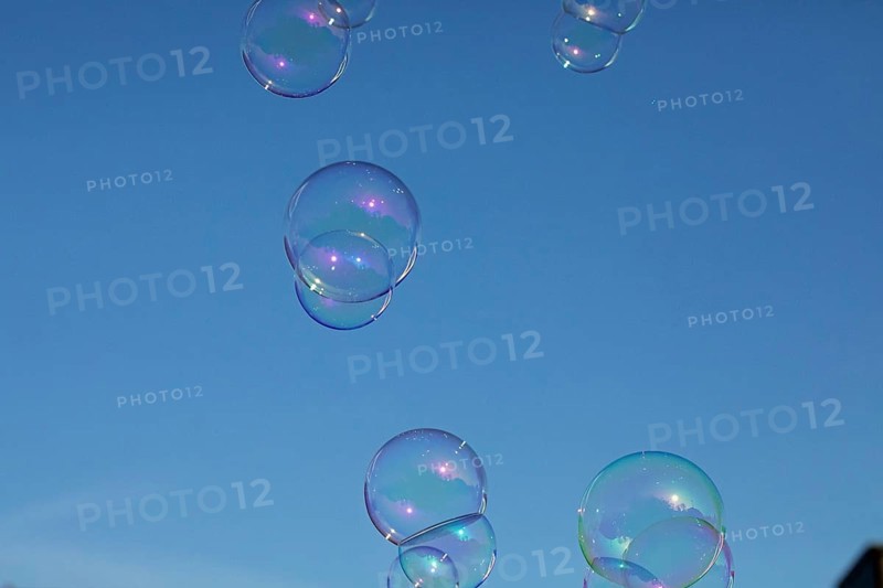 Soap bubbles several coloured films of soapy water on top of each other in front of a blue sky