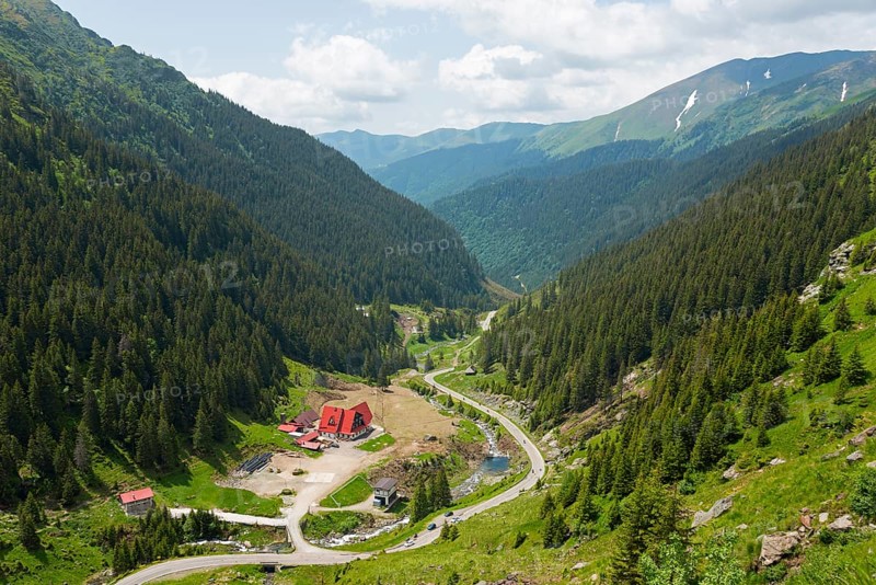 A green mountain valley with a river and a road, surrounded by dense forests, mountain road, Capra River, Transfogarasan High Road, Transfagarasan, TransfagaraÈ™an, FagaraÈ™ Mountains, Fagaras, Transylvania, Transylvania, Transylvania, Ardeal, Transilvania, Carpathians, Romania, Europe