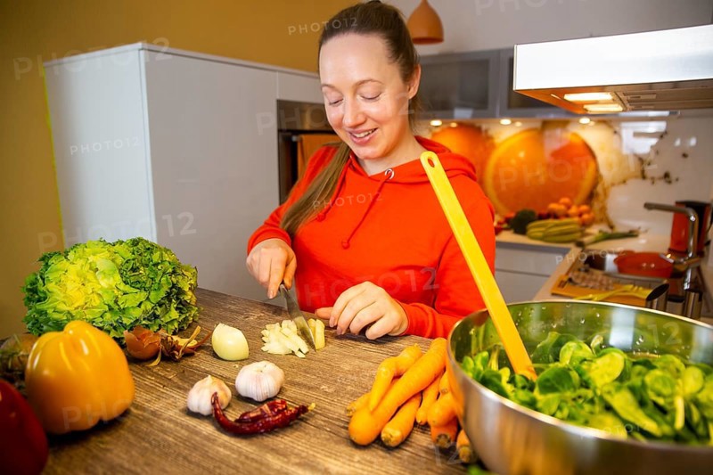 Vegan cooking: Young woman prepares lamb's lettuce