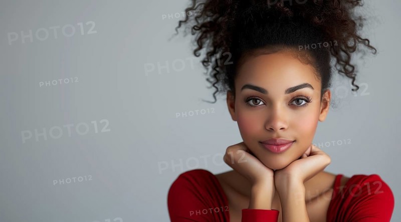 Smiling woman with afro, hands on chin, wearing red, portraying an engaging look, AI generated