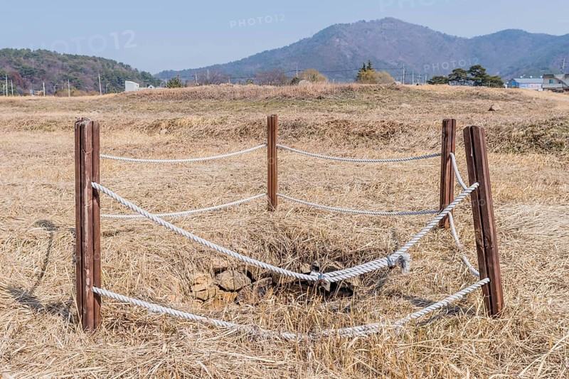 Water well cordoned off with wooden beams and rope at remains of stone fortress in Yeosu, South Korea, Asia
