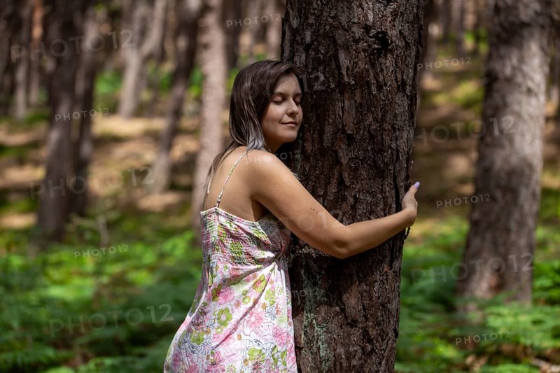 Young woman bathing in the forest (Shinrin Yoku), nature therapy from Japan