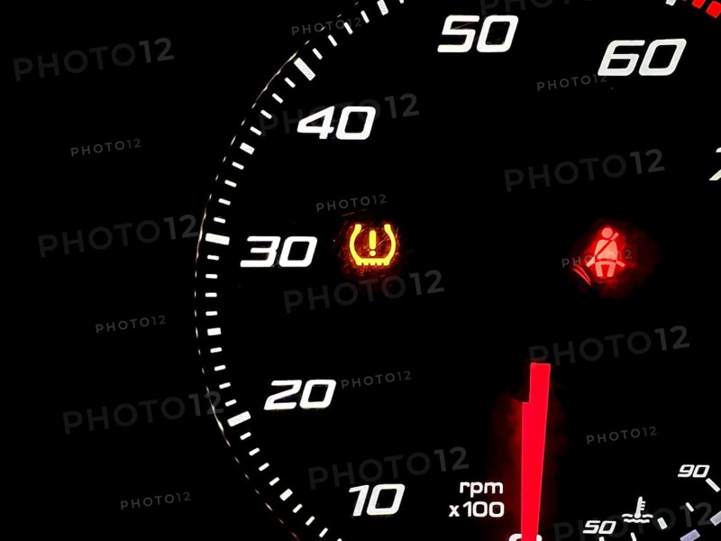 Car dashboard panel with light signal the belt is not fastened and the tire pressure is low. car safety concept, travel, vacation. vehicle check and control