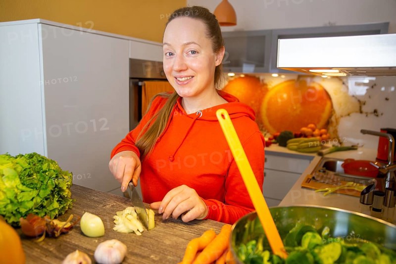 Vegan cooking: Young woman prepares lamb's lettuce