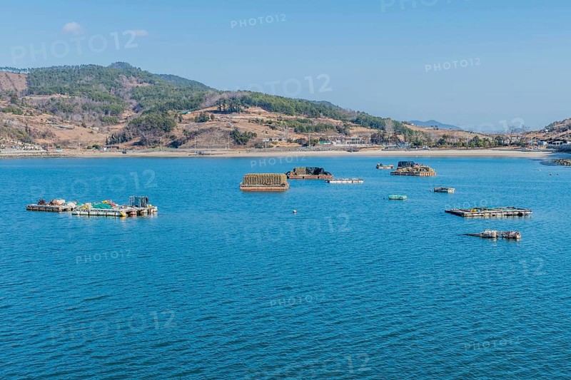 Floating docks loaded with fishing gear in water off island coastal seaport in Yeosu, South Korea, Asia