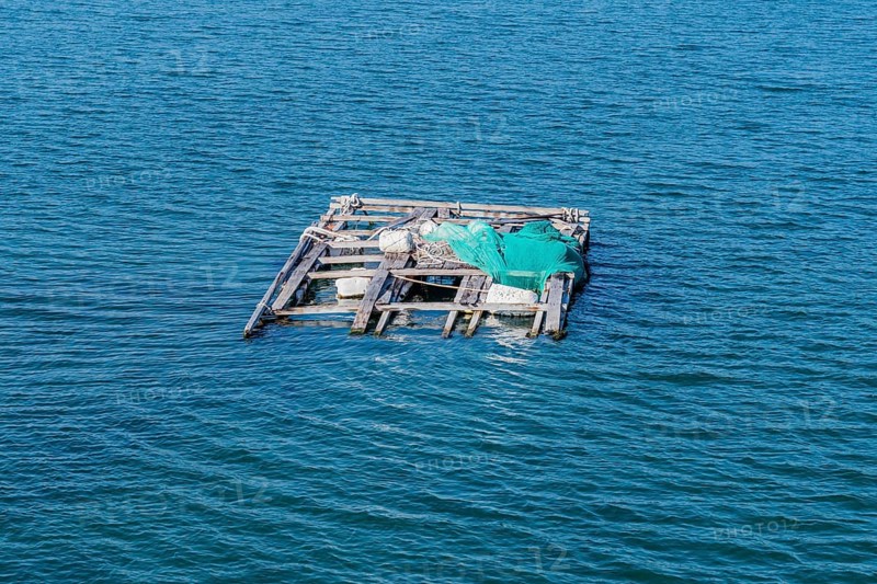 Dilapidated wooden raft held afloat with Styrofoam floats in ocean seaport in Yeosu, South Korea, Asia