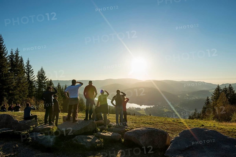 Hiking group, view from Hochfirst to Titisee and Feldberg, sunset, near Neustadt, Black Forest, Baden-Wuerttemberg, Germany, Europe