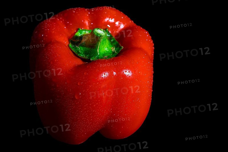Red capsicum with drops on the surface, dark background