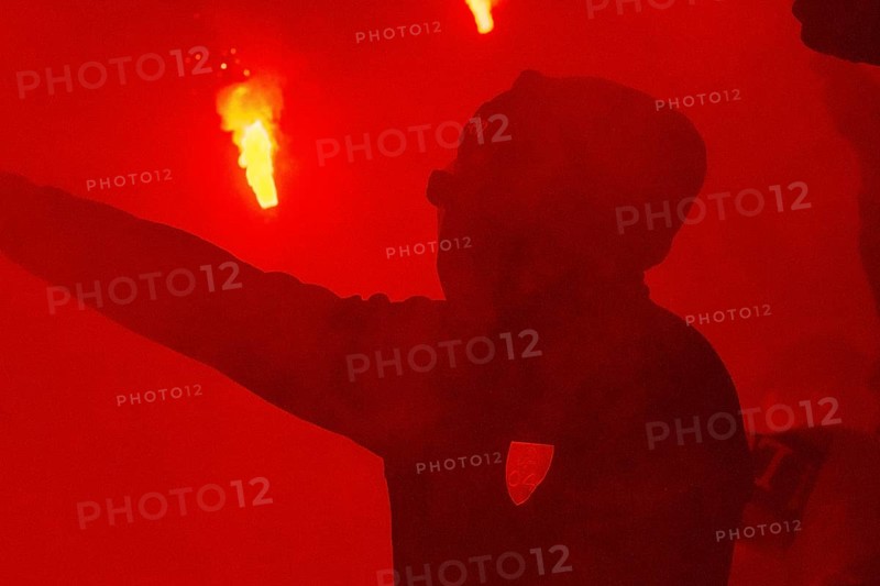BayArena Leverkusen, 6.2.2024, Football: DFB Pokal 2023/24 quarter-final, Bayer 04 Leverkusen (B04) vs VfB Stuttgart (VFB) - masked Bayer 04 fan in the beacon of Bengalos (DFL DFB REGULATIONS PROHIBIT ANY USE OF PHOTOGRAPHS AS IMAGE SEQUENCES AND/OR QUASI-VIDEO)