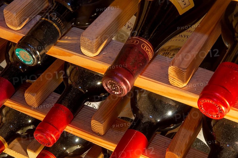 Wine cellar with red wine bottles (editorial)