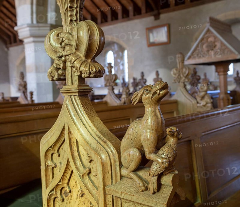 Carved pew bench ends inside All Saints church, Hollesley, Suffolk, England, UK