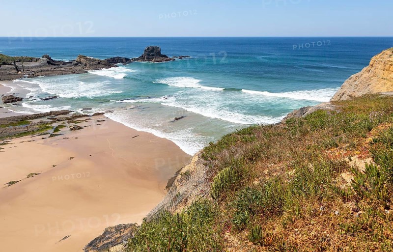 Sandy Carvalhal beach in bay between rocky headlands at Parque Natural do Sudoeste Alentejano e Costa Vicentina, Costa Vicentina natural park, near Brejao, south west Alentejo, Alentejo Littoral, Portugal, Southern Europe, Europe