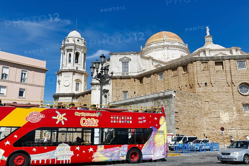 Red double-decker bus with tourists in front of the cathedral of Cadiz, Cathedral of the Holy Cross above the sea, Sightseeing, Cadiz, Andalusia, Spain, Europe