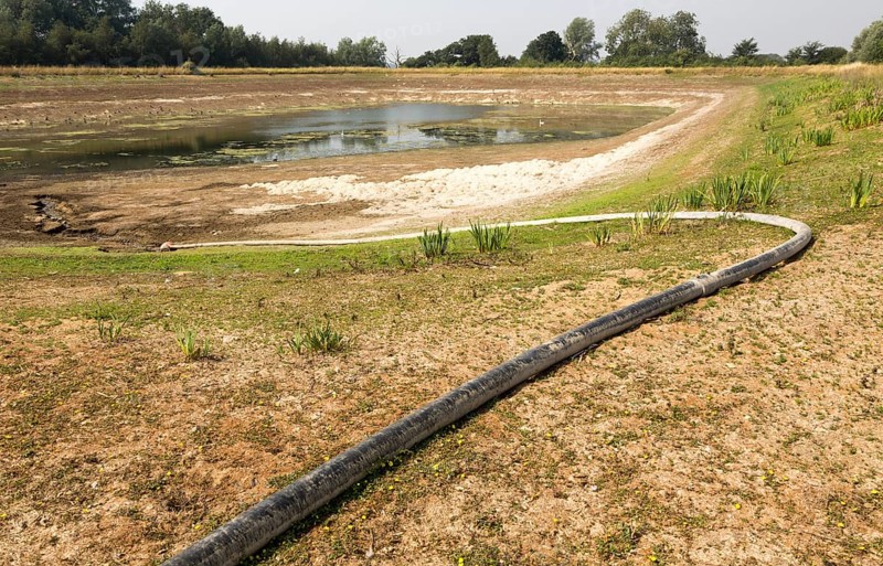 27 July 2018 Low water level in farm irrigation lake after long summer drought, Sutton, Suffolk England, UK