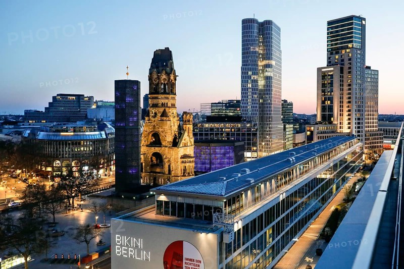 View of Breitscheidplatz in the evening with the Bikini building, the Kaiser Wilhelm Memorial Church, the Walldorf Astoria Hotel and the Upper West skyscraper, Berlin, 27.04.2021