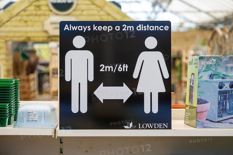 Social Distancing 2 metres apart information notice sign in Lowden garden centre shop, Wiltshire, England, UK, May 2020