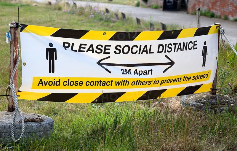 Please Social Distance 2 metres apart banner Avoid close contact with others to prevent the spread, UK