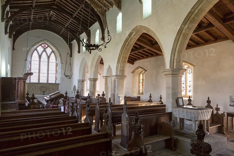 Interior of historic wooden pews, wooden roof beams, whitewashed walls and columns, All Saints church, South Elmham, Suffolk, England, UK, church in In the care of the Churches Conservation Trust