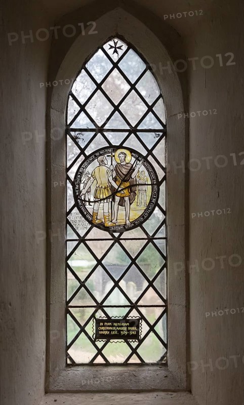 Church of John the Baptist, Barnby, Suffolk, England, UK stained glass roundel window by Margaret Edith Aldrich Rope Saint John the Baptist and Roman soldier