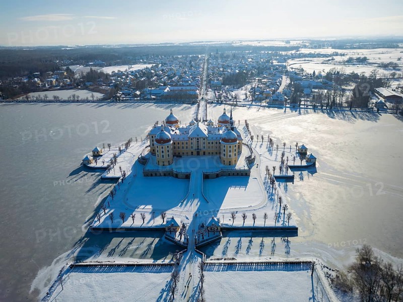 Moritzburg Castle on the castle island surrounded by the frozen castle pond, Moritzburg, Saxony, Germany, Europe