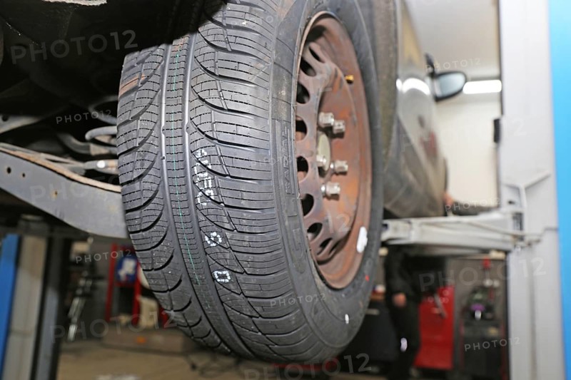 Fitting new all-weather tyres in the garage (editorial)