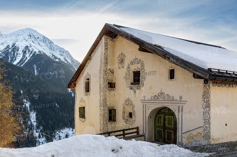 Historic house, sgraffito, facade decorations, mountain peak, snow, winter, Guarda, Engadin, Grisons, Switzerland, Europe