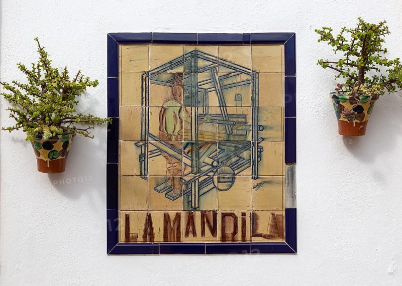 Close up of ceramic tile sign for textile workshop outside bar restaurant, Nijar, Almeria, Spain, Europe