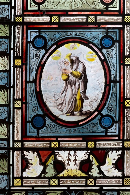 Flemish images in stained glass window church of Saint John, Saxmundham, Suffolk, England, UK hermit and four seasons