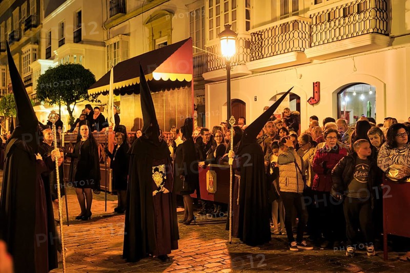 Nazarenos with black robes and typical pointed bonnets, insignia, Semana Santa, procession, night shot, celebrations in Tarifa, Spain, Europe