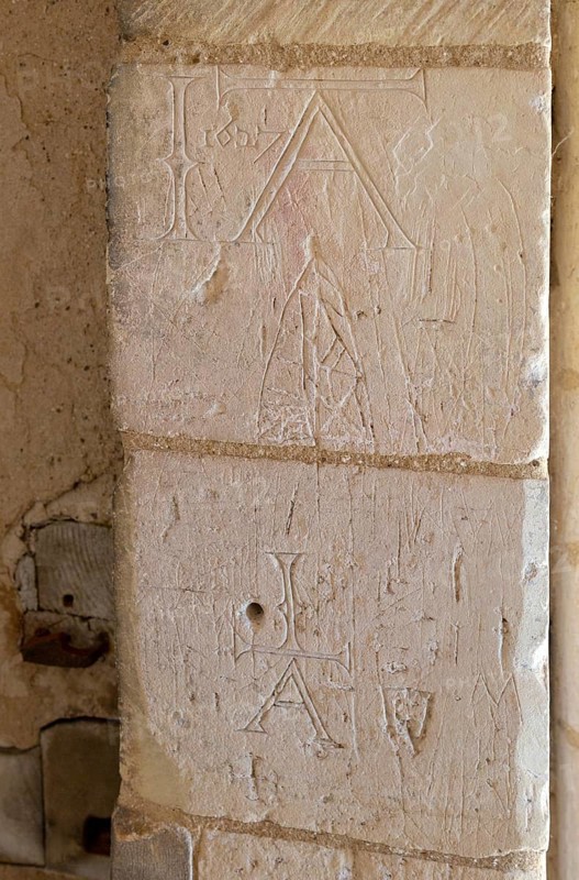 Initials names graffiti carved into stone of doorway at Church of St George South Elmham St Cross, Suffolk, England, UK