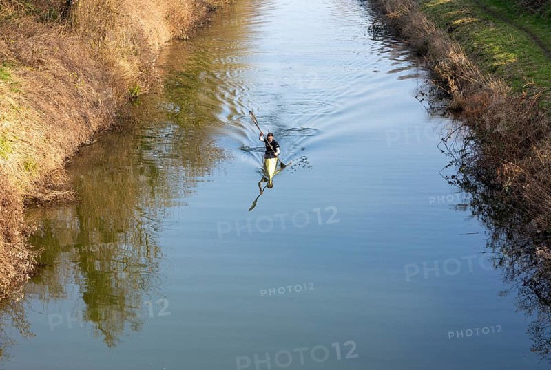 Female canoeist practising on Kennet and Avon canal, Devizes, Wiltshire, England, UK