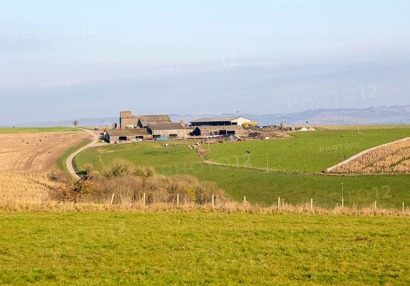 Hilltop farm buildings in chalk landscape, Casterley Barn, Salisbury Plain, Wiltshire, England, UK Pewsey Vale in distance