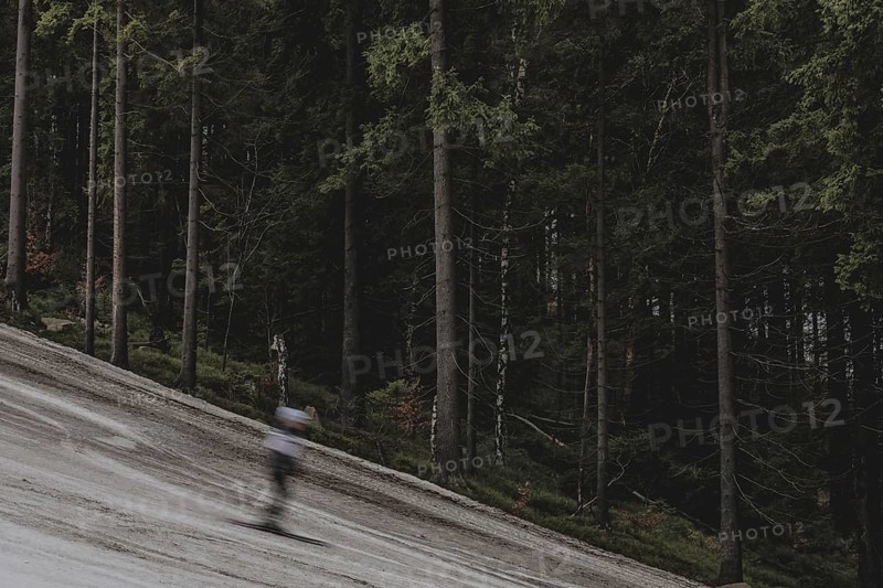 A skier skis on an artificially snow-covered and dirty slope, taken on a ski slope in the Jizera Mountains ski resort near Albrechtice v Jizerskych Horach, 05.02.2024. The Czech low mountain range with its ski resort is affected by increasingly warmer and shorter winters