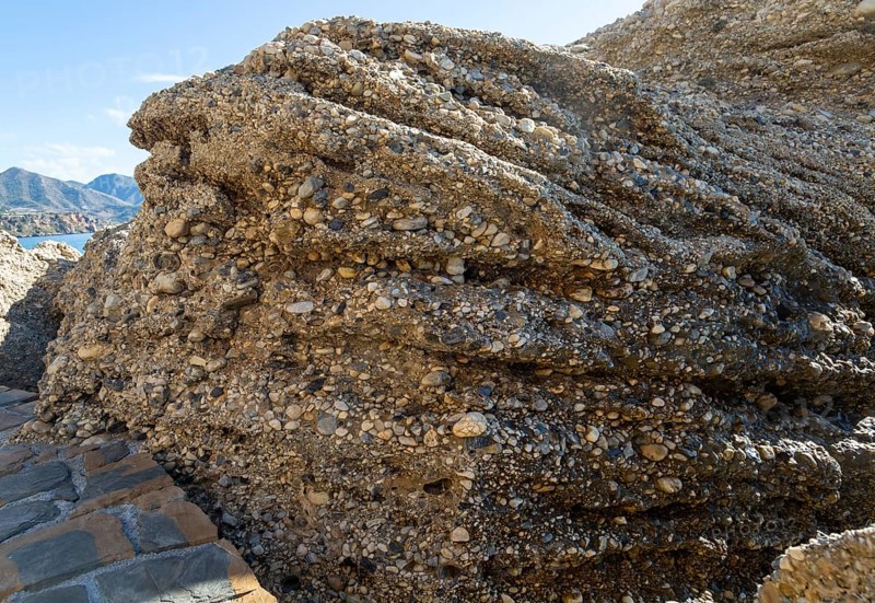Close up of coastal cliff composed of conglomerate sedimentary rocks at Nerja, Andalusia, Spain, Europe