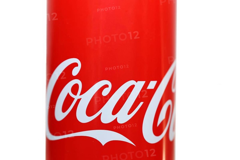 Close-up of a Coca-Cola can against a white background