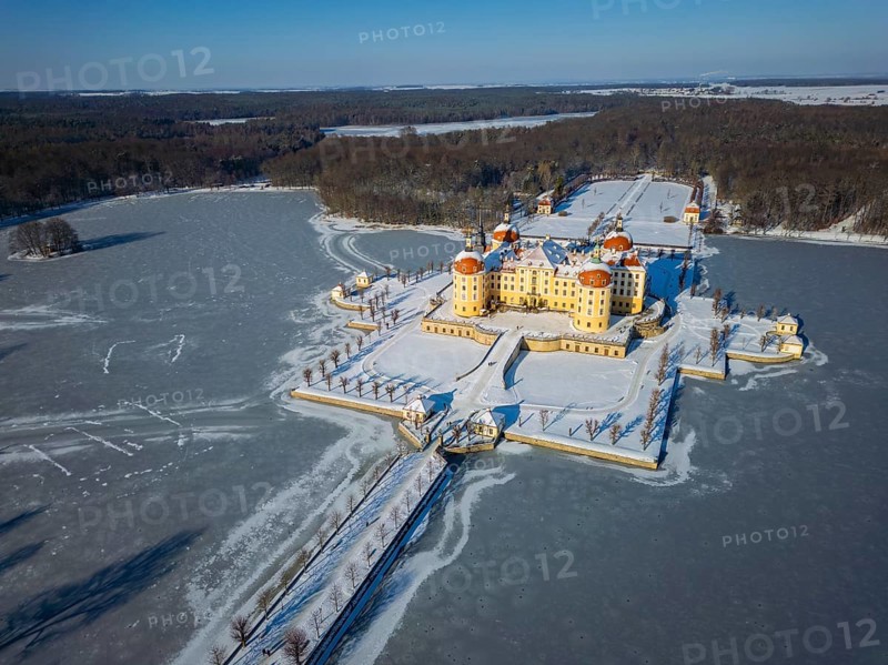 Moritzburg Castle on the castle island surrounded by the frozen castle pond, Moritzburg, Saxony, Germany, Europe