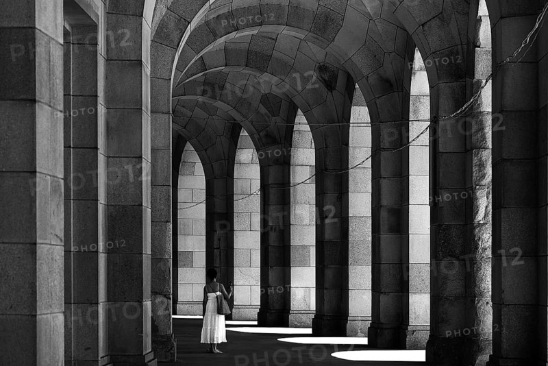 Lady in a white dress in the arcade of the Congress Hall, unfinished National Socialist monumental building on the Nazi Party Rally Grounds, Nuremberg, Middle Franconia, Bavaria, Germany, Europe