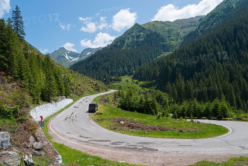 Camper on a winding mountain road, surrounded by forest and snow, mountain road, Transfogarasan high road, Transfagarasan, TransfagaraÈ™an, FagaraÈ™ Mountains, Fagaras, Transylvania, Transylvania, Transylvania, Ardeal, Transilvania, Carpathians, Romania, Europe